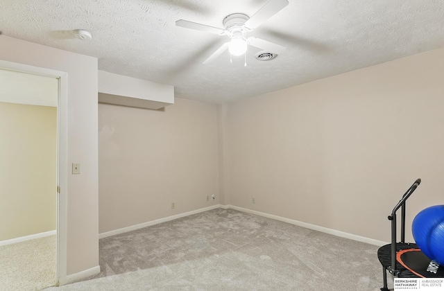 17819 Nicholas Rd, Plattsmouth, NE 68048 - basement with light carpet, ceiling fan, a textured ceiling, and baseboards