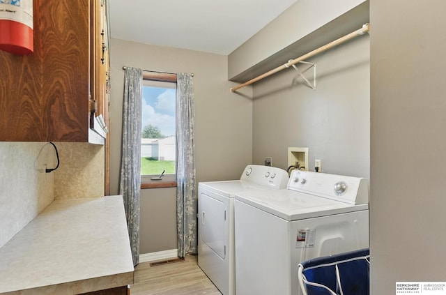 17819 Nicholas Rd, Plattsmouth, NE 68048 - washroom featuring separate washer and dryer, light wood-type flooring, and baseboards