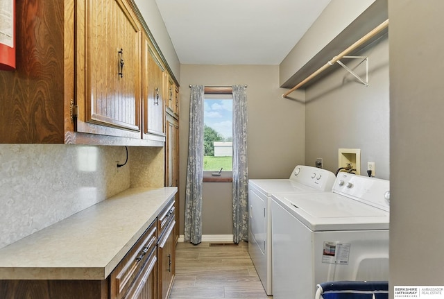 17819 Nicholas Rd, Plattsmouth, NE 68048 - washroom featuring cabinet space, separate washer and dryer, baseboards, and light wood finished floors