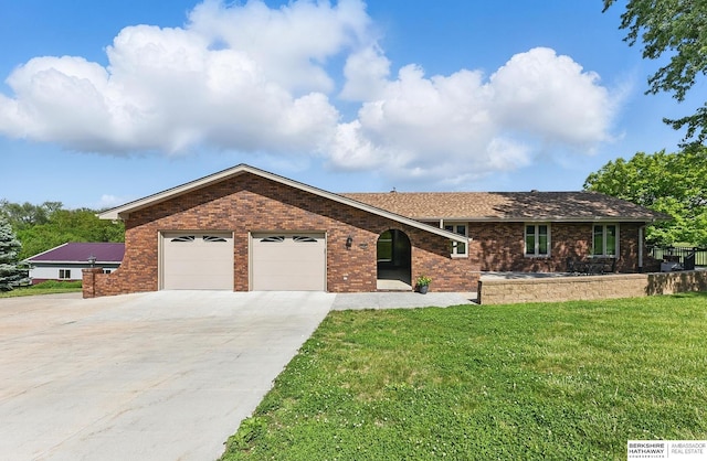 17819 Nicholas Rd, Plattsmouth, NE 68048 - ranch-style house with a garage, brick siding, concrete driveway, and a front lawn