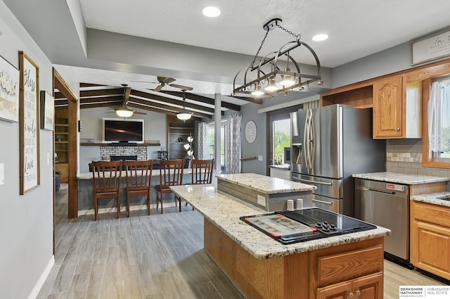 17819 Nicholas Rd, Plattsmouth, NE 68048 - kitchen featuring a kitchen island, stainless steel appliances, ceiling fan, light stone countertops, and recessed lighting