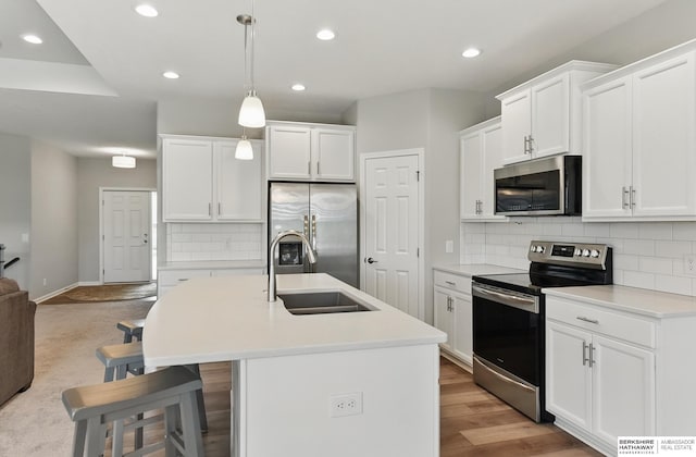 10280 S 209th St, Gretna, NE 68028 - kitchen featuring appliances with stainless steel finishes, a sink, a kitchen island with sink, recessed lighting, and tasteful backsplash