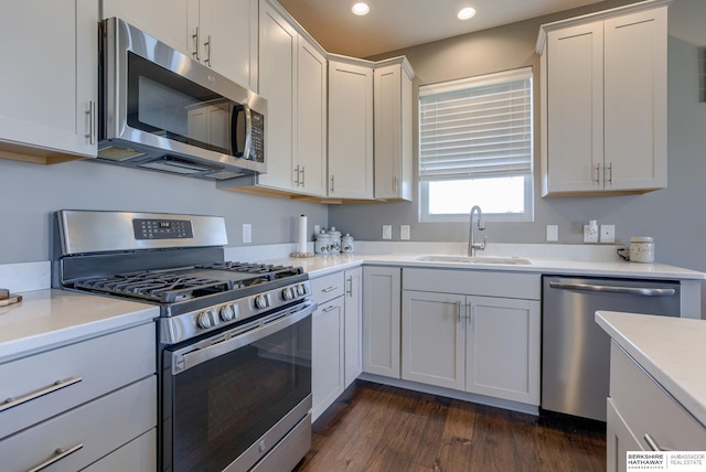 2310 Acorn Dr, Plattsmouth, NE 68048 - kitchen featuring stainless steel appliances, a sink, recessed lighting, dark wood-style flooring, and light countertops