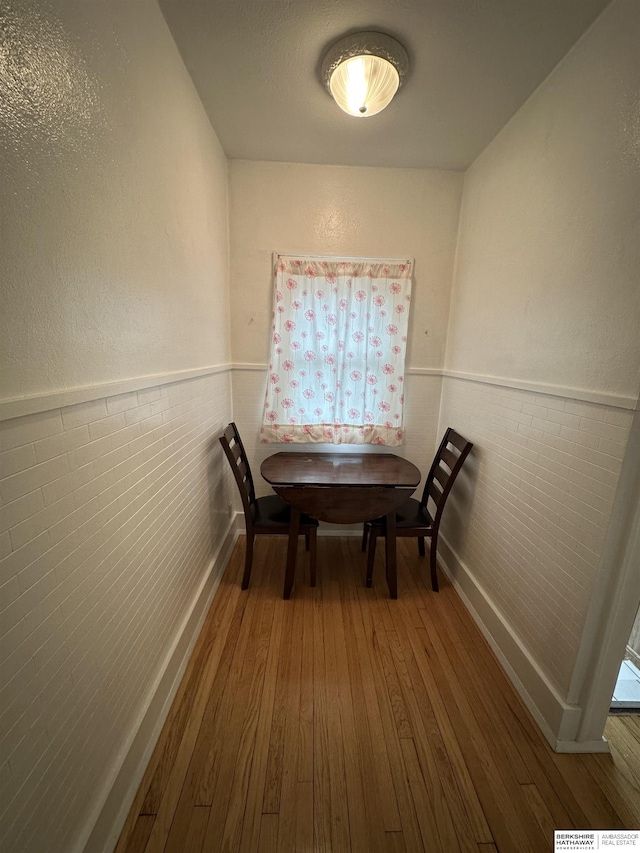 2002 Warren St, Bellevue, NE 68005 - dining area with hardwood / wood-style floors, a wainscoted wall, and baseboards