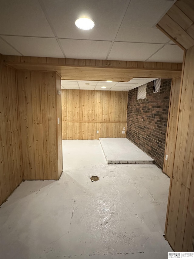 2002 Warren St, Bellevue, NE 68005 - finished basement featuring wood walls, a paneled ceiling, and brick wall