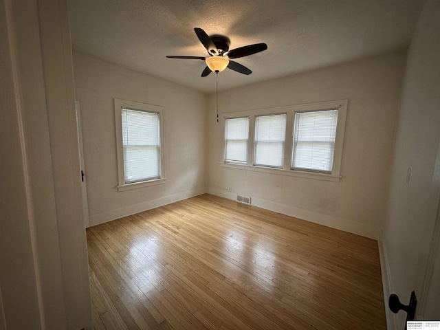 2002 Warren St, Bellevue, NE 68005 - unfurnished room featuring baseboards, a ceiling fan, light wood-type flooring, and a textured ceiling