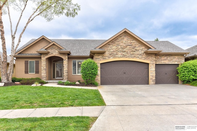 1414 S 189th Ct, Omaha, NE 68130 - view of front of home with stone siding, a garage, concrete driveway, and a front lawn