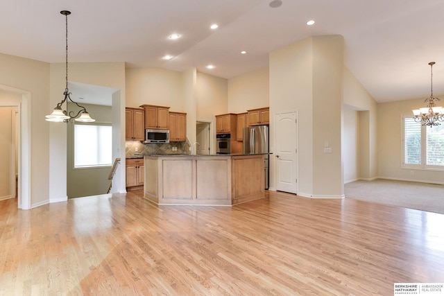 1414 S 189th Ct, Omaha, NE 68130 - kitchen featuring stainless steel appliances, open floor plan, dark countertops, a chandelier, and tasteful backsplash