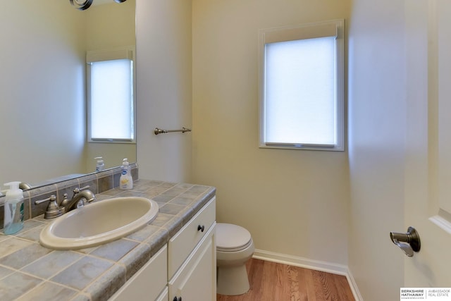 1414 S 189th Ct, Omaha, NE 68130 - bathroom with wood finished floors, toilet, vanity, and baseboards