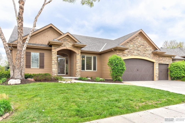 1414 S 189th Ct, Omaha, NE 68130 - view of front of house featuring stone siding, an attached garage, concrete driveway, a front lawn, and a shingled roof