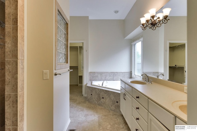 1414 S 189th Ct, Omaha, NE 68130 - bathroom with a spacious closet, a bath, double vanity, and a chandelier