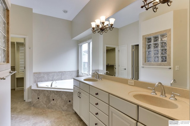 1414 S 189th Ct, Omaha, NE 68130 - full bath with a chandelier, a bath, double vanity, a spacious closet, and tile patterned floors