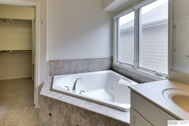 1414 S 189th Ct, Omaha, NE 68130 - full bathroom with a spacious closet, a whirlpool tub, vanity, and baseboards