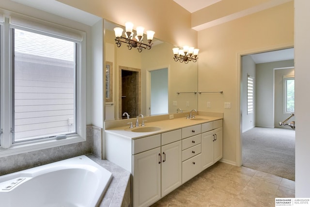 1414 S 189th Ct, Omaha, NE 68130 - bathroom featuring a chandelier, a relaxing tiled tub, double vanity, and tile patterned floors