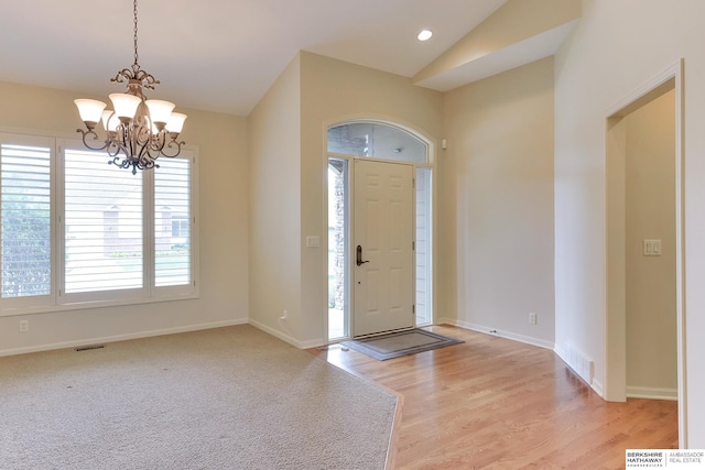 1414 S 189th Ct, Omaha, NE 68130 - entrance foyer featuring lofted ceiling, a chandelier, light wood-style floors, and baseboards