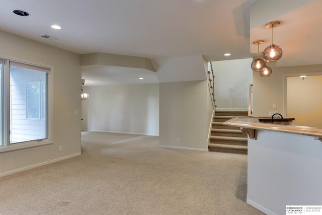 1414 S 189th Ct, Omaha, NE 68130 - unfurnished living room featuring light carpet, stairs, baseboards, and recessed lighting