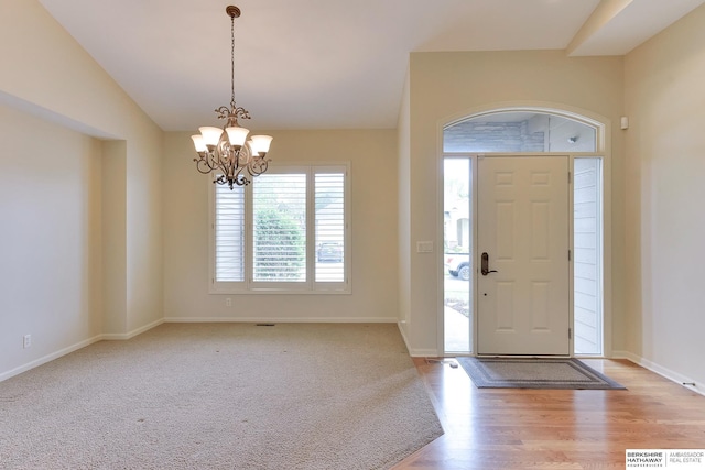 1414 S 189th Ct, Omaha, NE 68130 - foyer entrance with a chandelier, lofted ceiling, baseboards, and light wood-type flooring