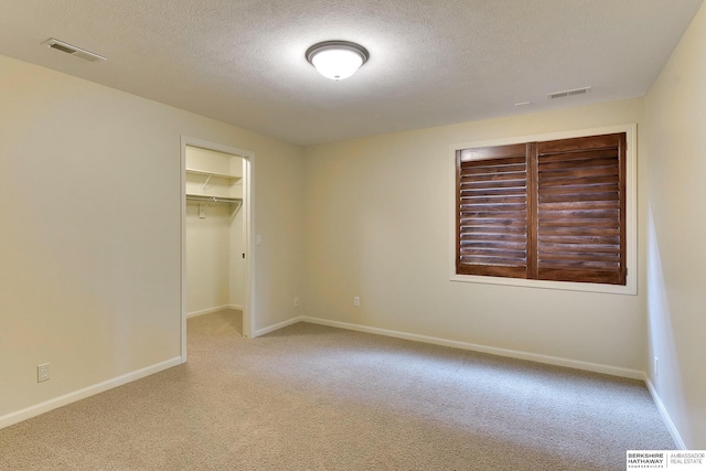 1414 S 189th Ct, Omaha, NE 68130 - unfurnished bedroom with carpet, a textured ceiling, baseboards, a spacious closet, and a closet