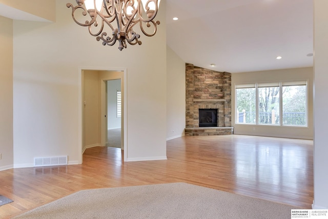 1414 S 189th Ct, Omaha, NE 68130 - unfurnished living room featuring a chandelier, wood finished floors, a fireplace, recessed lighting, and baseboards
