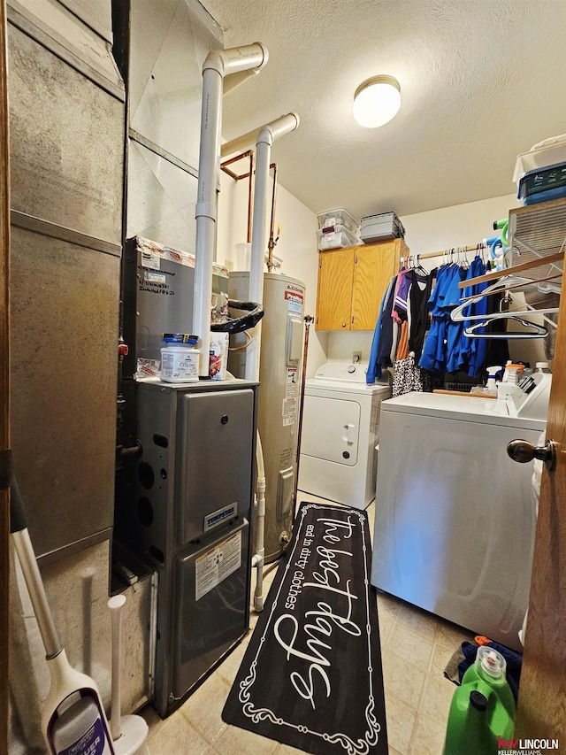 10531 N 137th St, Waverly, NE 68462 - washroom with washing machine and dryer, electric water heater, cabinet space, a textured ceiling, and light tile patterned floors