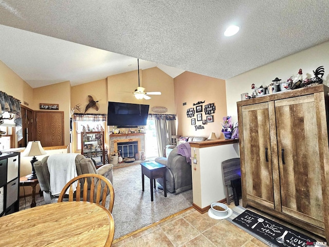 10531 N 137th St, Waverly, NE 68462 - living room featuring ceiling fan, vaulted ceiling, a textured ceiling, a glass covered fireplace, and baseboards