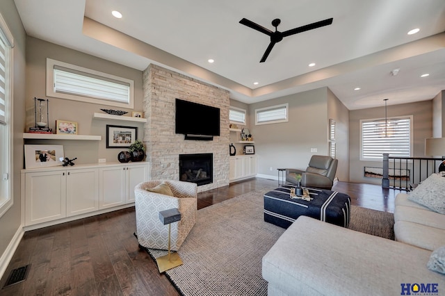 8947 Himark Ln, Lincoln, NE 68526 - living room with ceiling fan, a fireplace, dark wood finished floors, baseboards, and plenty of natural light