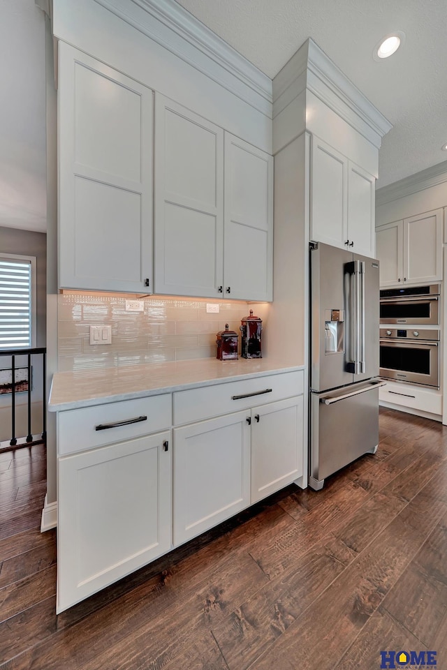 8947 Himark Ln, Lincoln, NE 68526 - kitchen featuring stainless steel appliances, recessed lighting, dark wood-style floors, light countertops, and backsplash