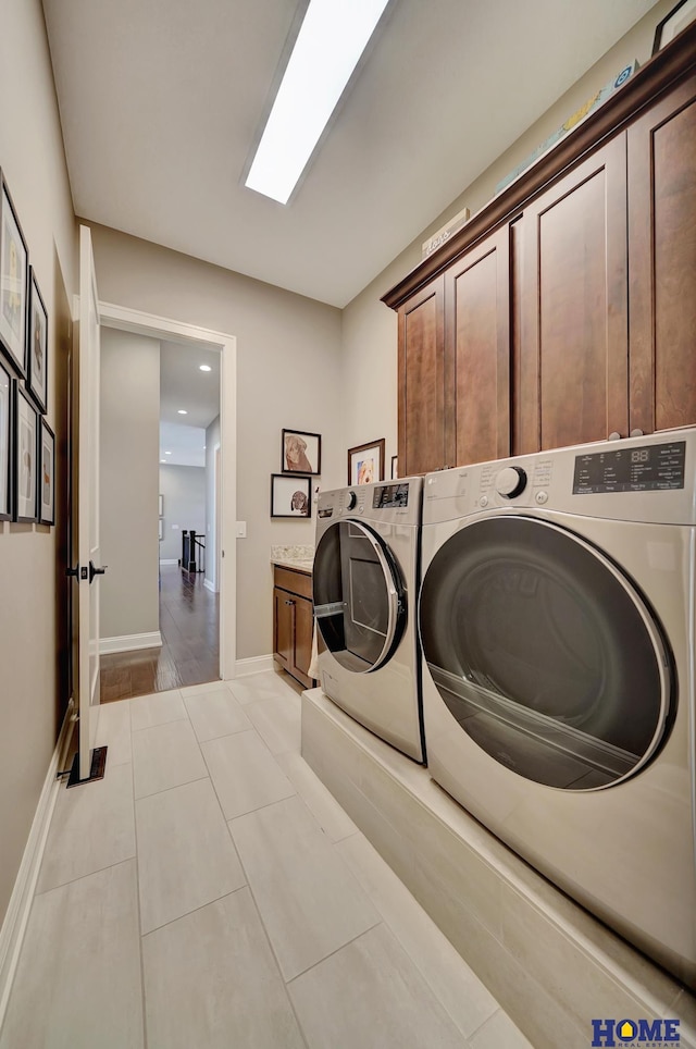 8947 Himark Ln, Lincoln, NE 68526 - laundry area featuring cabinet space, washing machine and dryer, baseboards, and recessed lighting