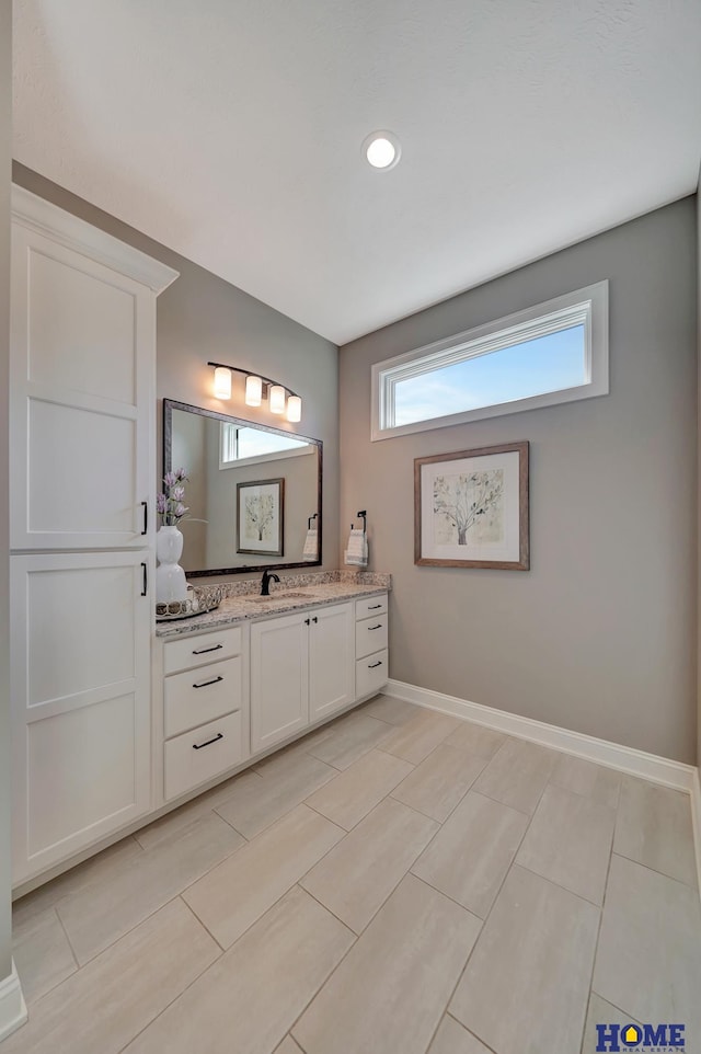 8947 Himark Ln, Lincoln, NE 68526 - bathroom featuring vanity, baseboards, and recessed lighting
