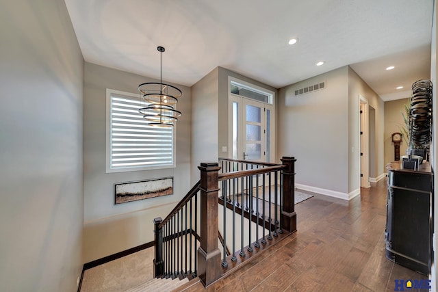 8947 Himark Ln, Lincoln, NE 68526 - staircase with wood finished floors, baseboards, recessed lighting, and a chandelier