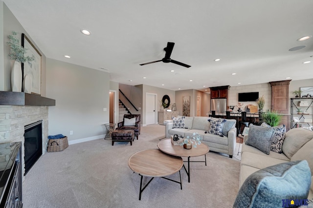 8947 Himark Ln, Lincoln, NE 68526 - living area with stairway, light carpet, recessed lighting, ceiling fan, and a stone fireplace