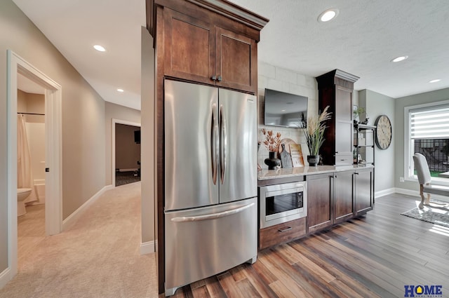 8947 Himark Ln, Lincoln, NE 68526 - kitchen with stainless steel appliances, baseboards, recessed lighting, light countertops, and dark brown cabinets