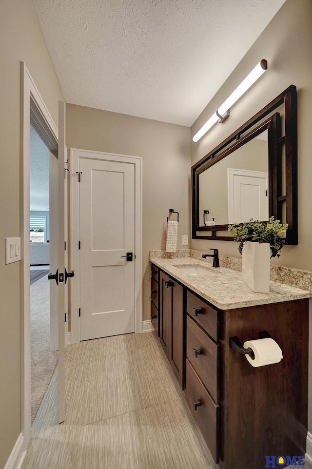 8947 Himark Ln, Lincoln, NE 68526 - bathroom with vanity, baseboards, and a textured ceiling