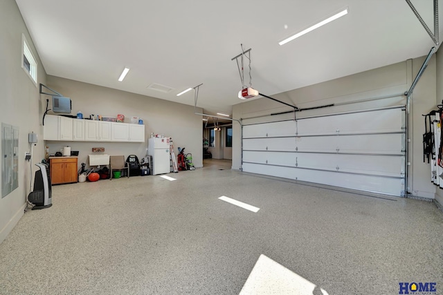 8947 Himark Ln, Lincoln, NE 68526 - garage with a garage door opener and freestanding refrigerator