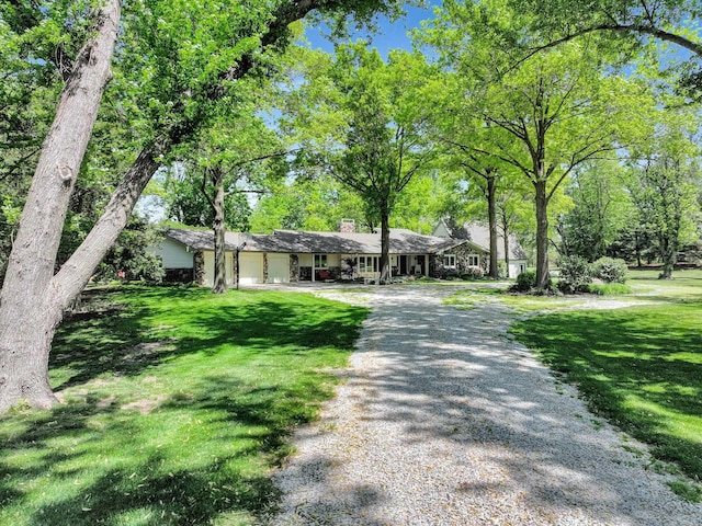 9900 Van Dorn St, Lincoln, NE 68520 - single story home featuring a chimney, driveway, a garage, and a front lawn