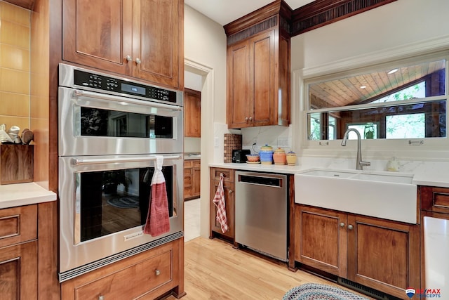 9900 Van Dorn St, Lincoln, NE 68520 - kitchen with appliances with stainless steel finishes, a sink, light wood-type flooring, lofted ceiling, and light countertops