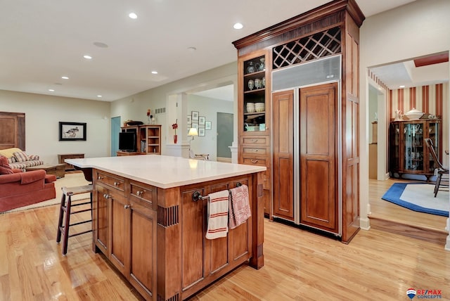 9900 Van Dorn St, Lincoln, NE 68520 - kitchen featuring paneled built in refrigerator, light wood-type flooring, open floor plan, a center island, and recessed lighting