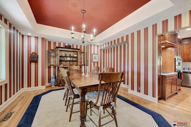 9900 Van Dorn St, Lincoln, NE 68520 - dining room featuring wallpapered walls, light wood finished floors, a raised ceiling, a chandelier, and baseboards