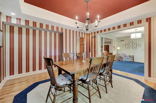 9900 Van Dorn St, Lincoln, NE 68520 - dining space with light wood-style floors, a chandelier, baseboards, a raised ceiling, and wallpapered walls