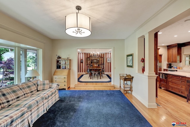 9900 Van Dorn St, Lincoln, NE 68520 - living area with a chandelier, light wood-type flooring, and baseboards