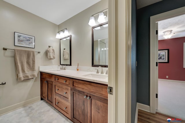 9900 Van Dorn St, Lincoln, NE 68520 - full bathroom featuring baseboards and double vanity