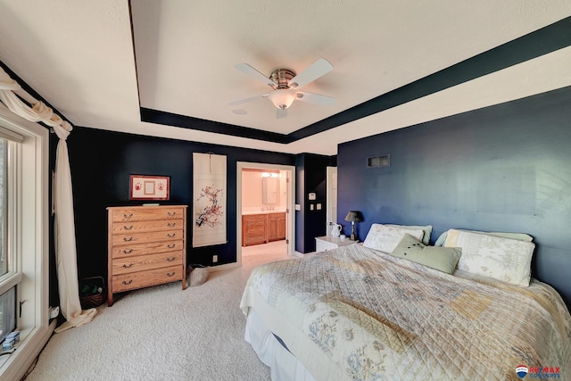 9900 Van Dorn St, Lincoln, NE 68520 - carpeted bedroom featuring a tray ceiling, connected bathroom, and ceiling fan