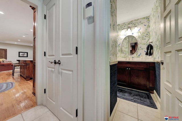 9900 Van Dorn St, Lincoln, NE 68520 - bathroom featuring wallpapered walls, tile patterned floors, and vanity