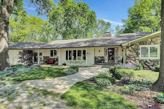 9900 Van Dorn St, Lincoln, NE 68520 - view of front of home featuring stone siding, a chimney, a front yard, and a shingled roof