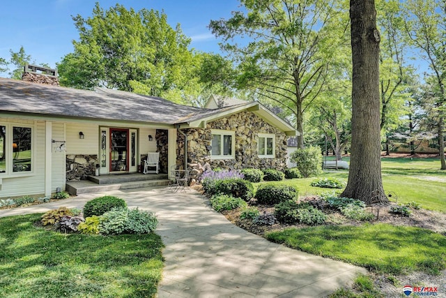 9900 Van Dorn St, Lincoln, NE 68520 - view of front of house with stone siding, a porch, and a front yard