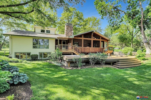 9900 Van Dorn St, Lincoln, NE 68520 - rear view of property with a chimney, a wooden deck, a sunroom, and a yard