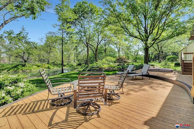 9900 Van Dorn St, Lincoln, NE 68520 - deck with view of wooded area, outdoor dining area, and a lawn