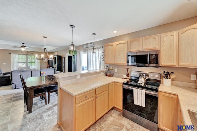 2222 SW Soukup Dr, Lincoln, NE 68522 - kitchen with appliances with stainless steel finishes, light brown cabinets, a peninsula, open floor plan, and light countertops