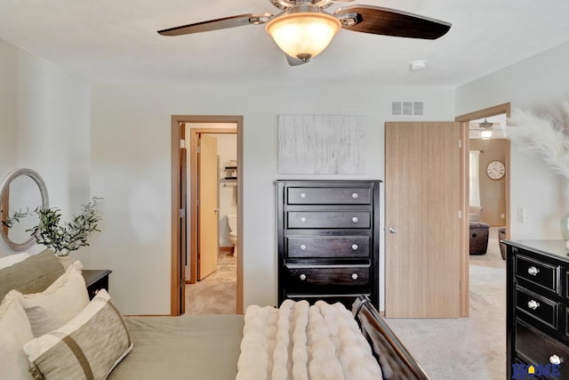 2222 SW Soukup Dr, Lincoln, NE 68522 - bedroom featuring light colored carpet, ensuite bathroom, and a ceiling fan