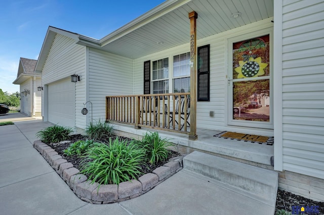 2222 SW Soukup Dr, Lincoln, NE 68522 - entrance to property featuring covered porch, a garage, and concrete driveway